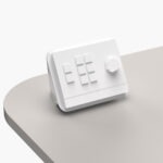 White desk-mounted housing for AMX Massio 8-Button Control Pad installed onto multimedia lectern worktop