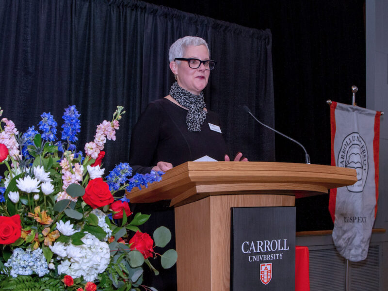 Our POD-4 AV podium lectern, shown here at Carroll University USA, is a custom podium with a timber finish and featuring a prominent logo panel. It includes electric height adjustment, input/output panels for convenient device connectivity and charging, and castor wheels for easy mobility. This lectern is user-friendly, portable, and stylish, making it ideal for hotels, conferences, function centres, corporate venues, sporting clubs, universities, and schools. Available for worldwide shipping, it’s a durable and reliable lectern for any event space.